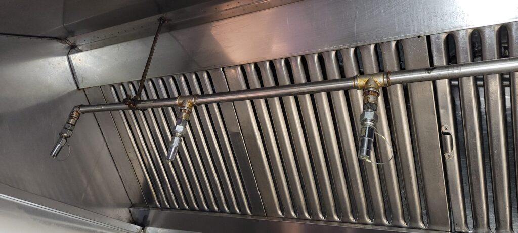 Commercial kitchen hood fire-suppression system